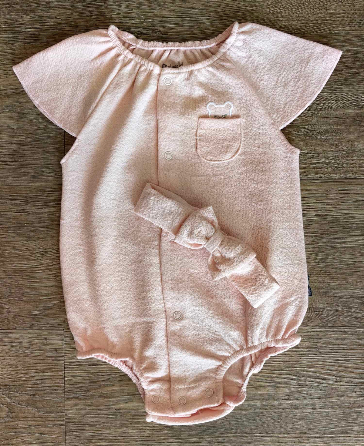 Barboteuse bébé fille en éponge avec poche brodée et bandeau à nœud
