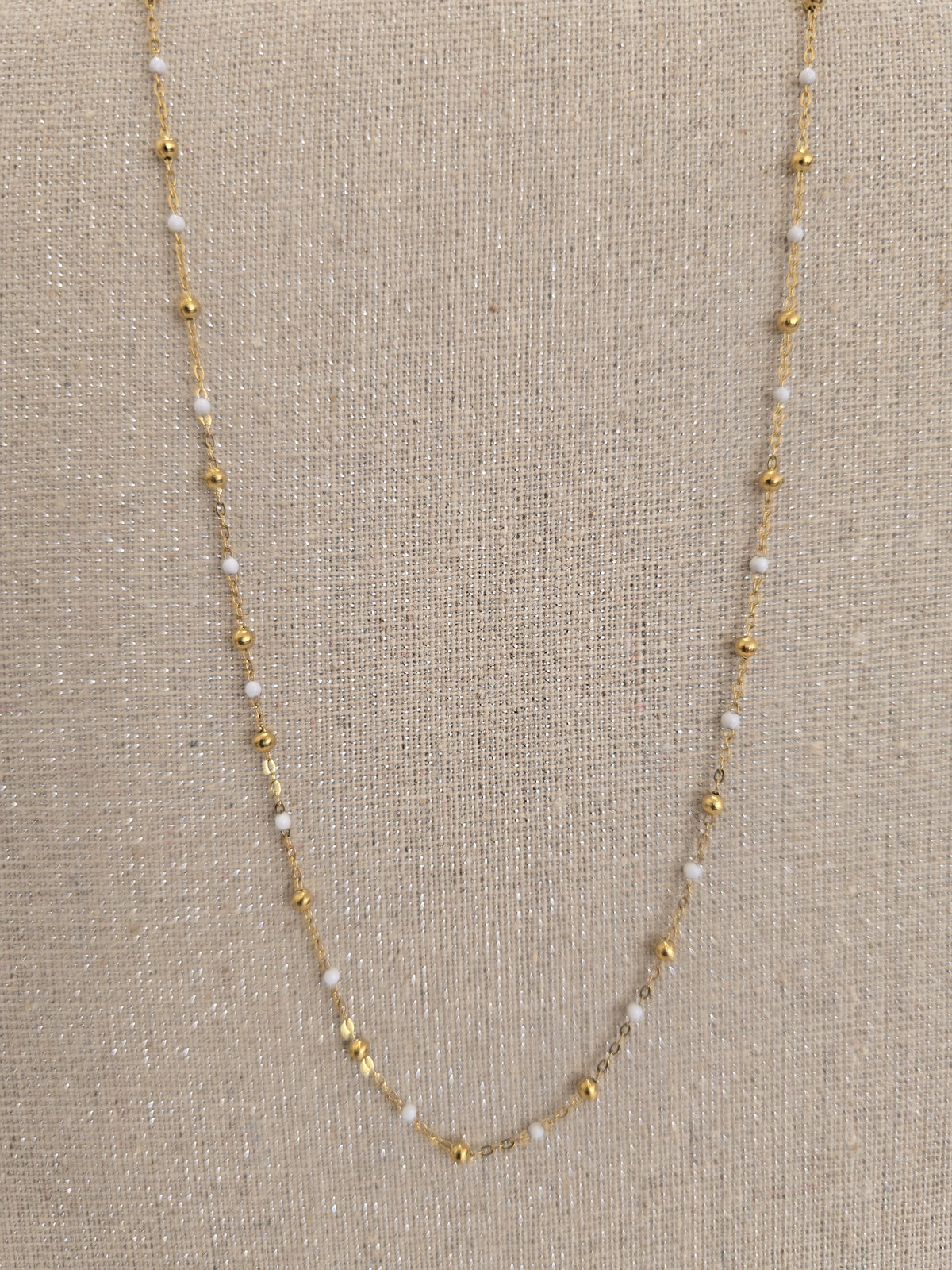Détail du collier femme perles blanches et perles dorées